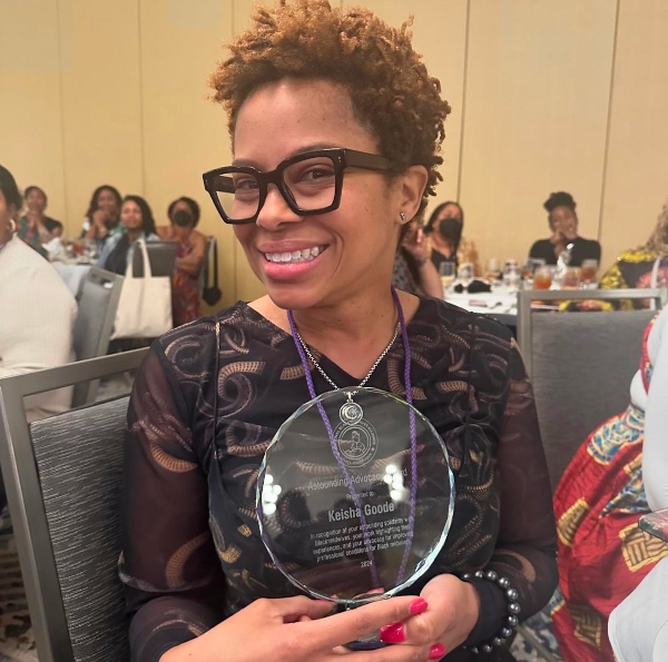 Photo of Dr. Keisha Goode with her Astounding Advocacy Award 