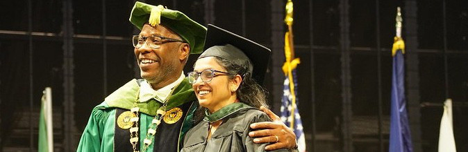 Dr Sams and graduating student smiling