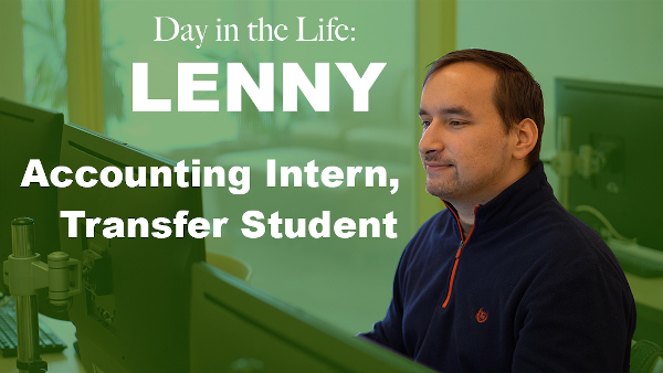 A day in the life: Lenny Accounting intern, transfer student. A white male student wearing navy colored half-zip sweatshirt smiling while looking at a computer screen