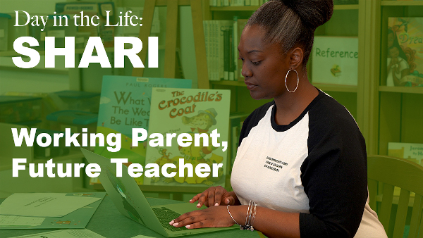 Day in the life: Shari Working parent, future teacher. Black female student wearing black and white t-shirt working on her laptop computer children's book and bookshelf displaying in background