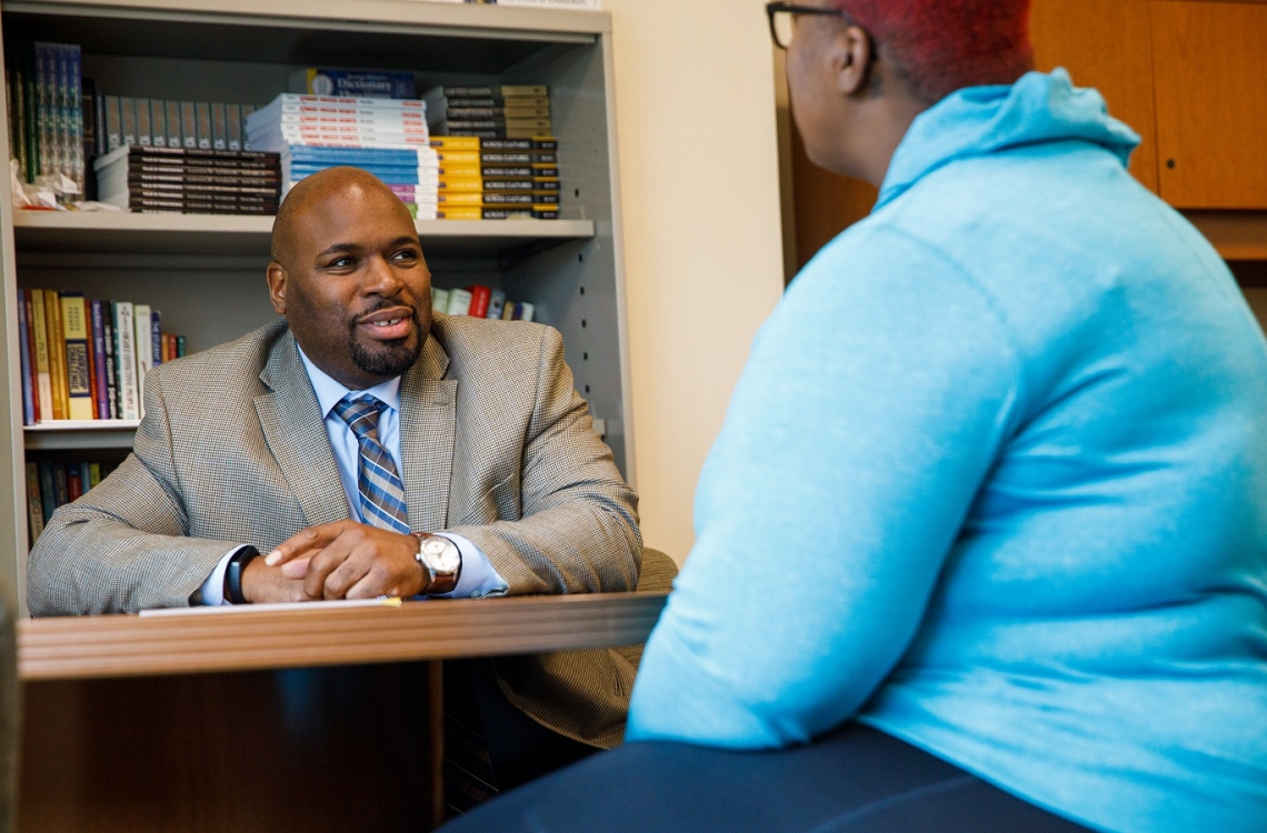 EOP Director Robinson talking with student