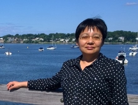 Portrait of Ruomei Gao overlooking a harbor