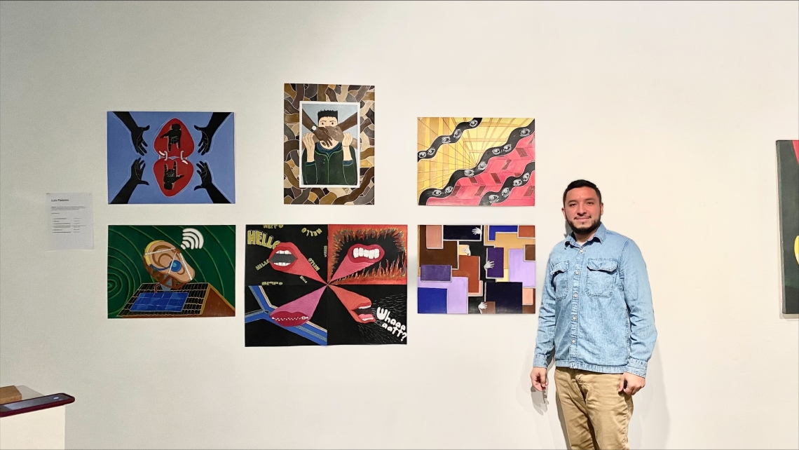 Luis Palomo with his art exhibit