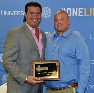 Manfredi with his hall of fame plaque standing with Peter Belotti