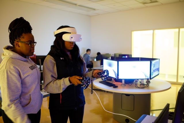 Two students experiment in the campus virtual reality lab