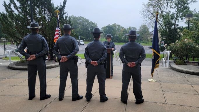Four University Police Officers standing at attention during the memorial
