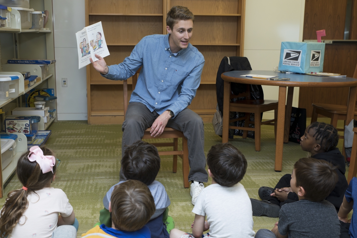 Graduate Student reading to students