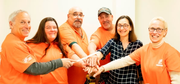 Photo of Home depot team with Claudia Newman,(second from right) and Terri Arce, Assistant Manager of Home Depot in Jericho