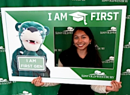 Student with sign showing she is First generation in College