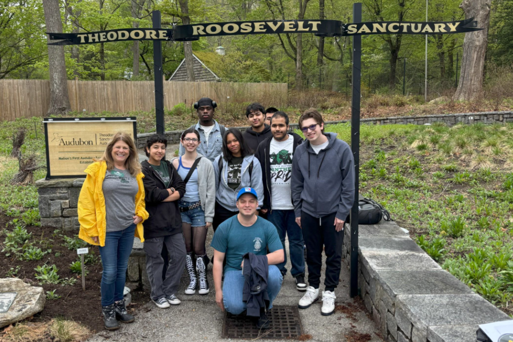 Group of 11 students and staff under a sign reading Theodore Roosevelt Preserve