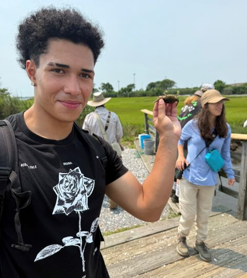 Young man holding a crab