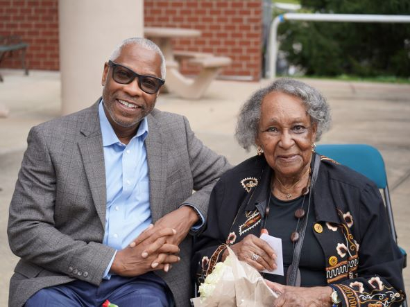 Black man sits with elderly black women