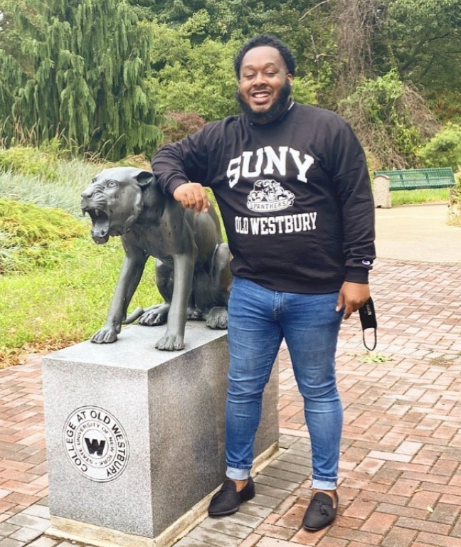 Kalief Metellus standing next to the Panther statue outside the Student Union