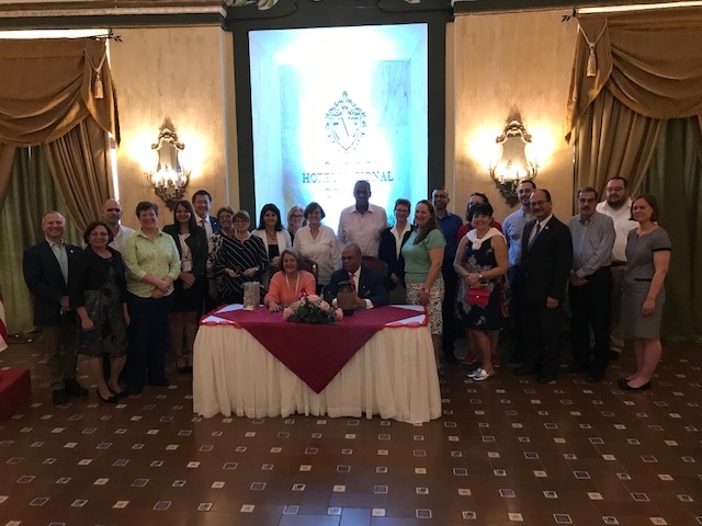 Higher education officials from New York and Cuba gather to congratulate President Butts and Dr. Finale on the completed agreement.