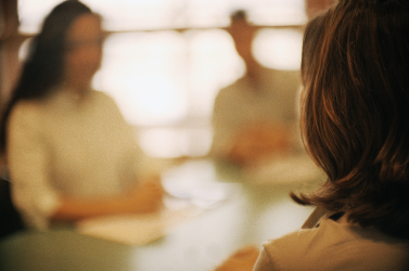 Blurred photo of a three-person discussion