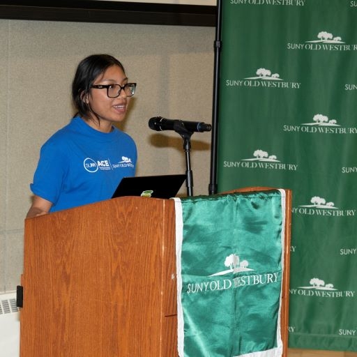 Young woman of Asian descent speaks from a podium