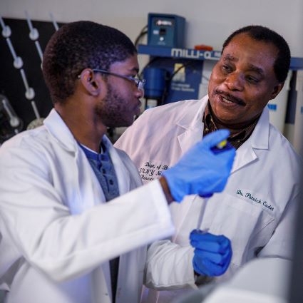 Two African American men in white lab coats