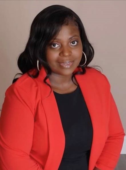 African American woman dressed professionally in a red blazer with black blouse