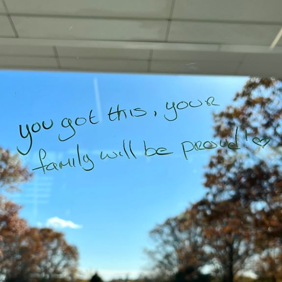 Window with handwritten message in magic marker