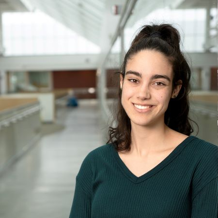 Hispanic young woman smiles at camera