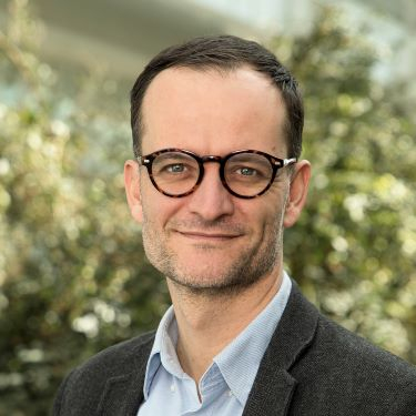 Hispanic male with eyeglasses wearing collared shirt and sport coat