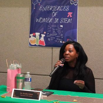 African American woman speaks into a microphone