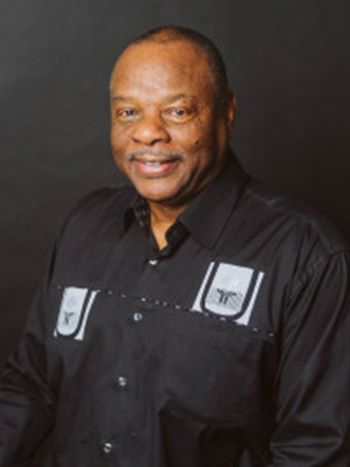African American man in black button-down shirt featuring two white rectangles