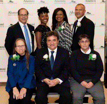 Photo of the 7 2019 honorees in front of the alumni association step-and-repeat