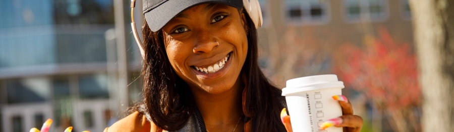 African American student enjoying coffee and music