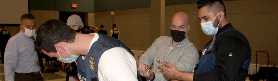 IRS Agent shows a student how to apply handcuffs during Adrian Project
