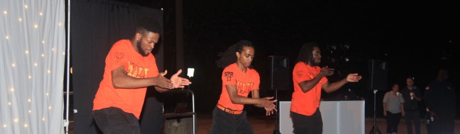 Three fraternity members "step" for the audience