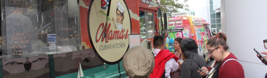 Four students ordering from a Cuban food truck