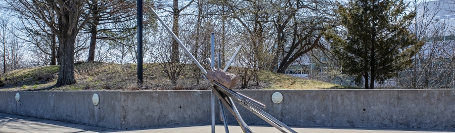 stone and steel sculpture near entry tunnel