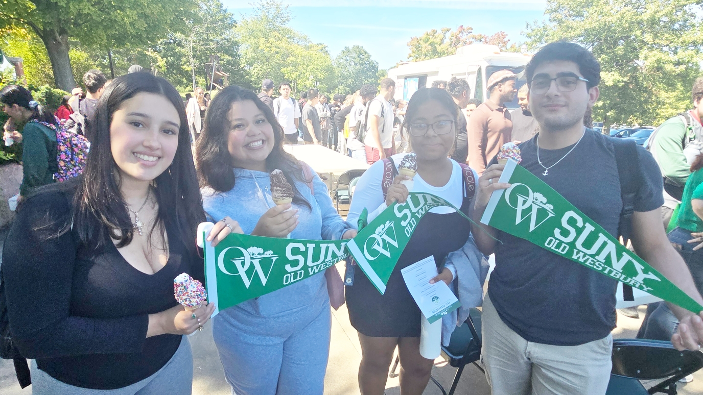 Four freshman students holding OW banners