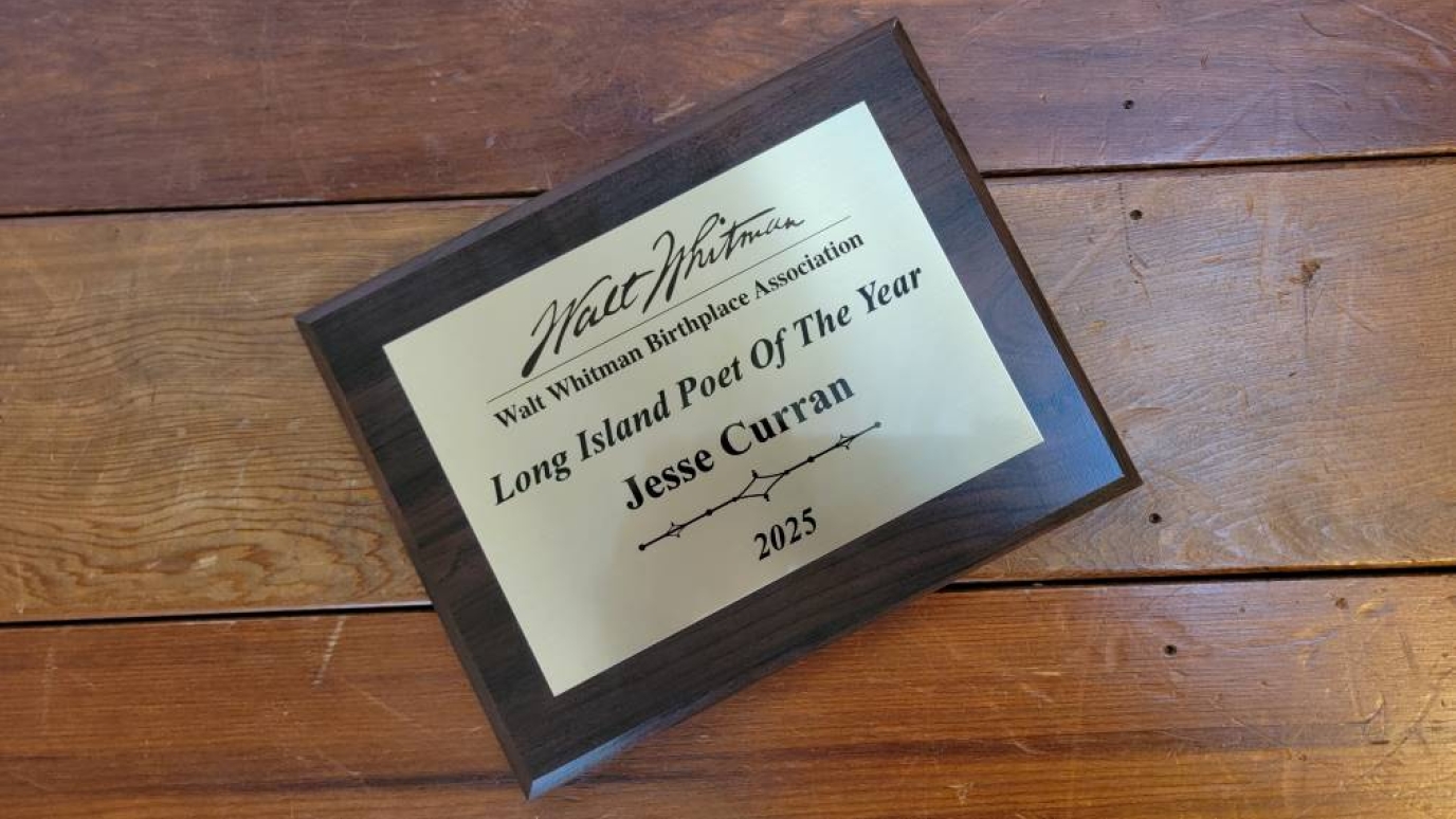 A plaque that reads Jesse Curran, 2025 Long Island Poet of the Year