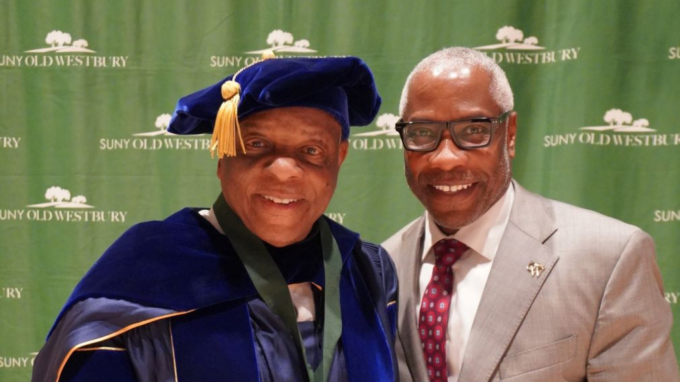 Two African American men smiling for the camera