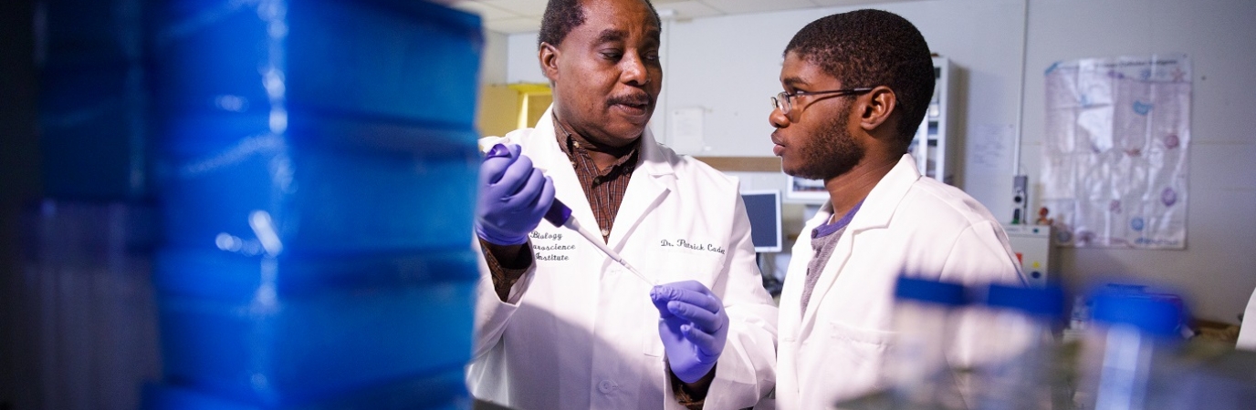 Biological Sciences Dr. Cadet in research lab with student