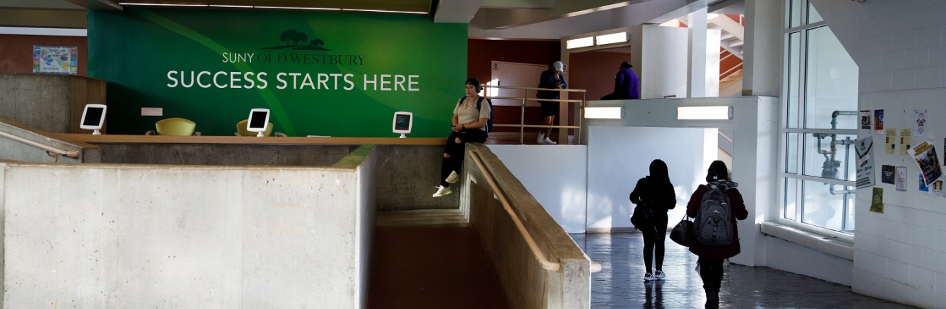 Students walking past the Success Starts Here kiosk