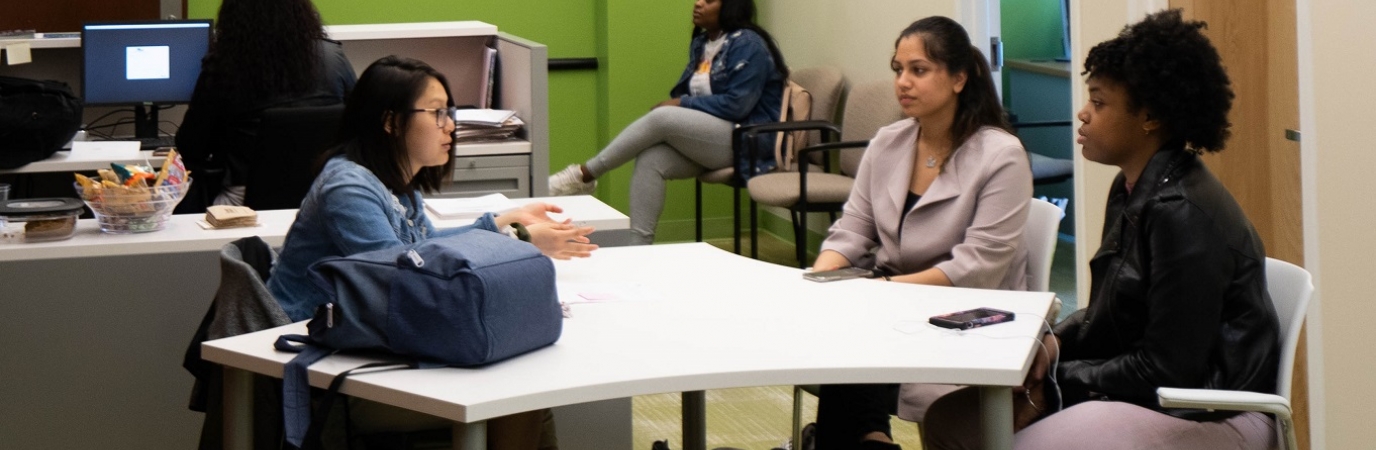 A counselor and two students in the Transfer Services Office