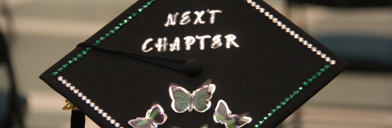 A mortarboard that reads "Next Chapter"
