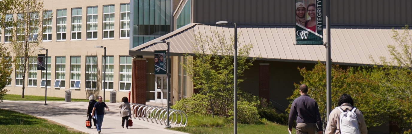 Students walk the path to the NAB building