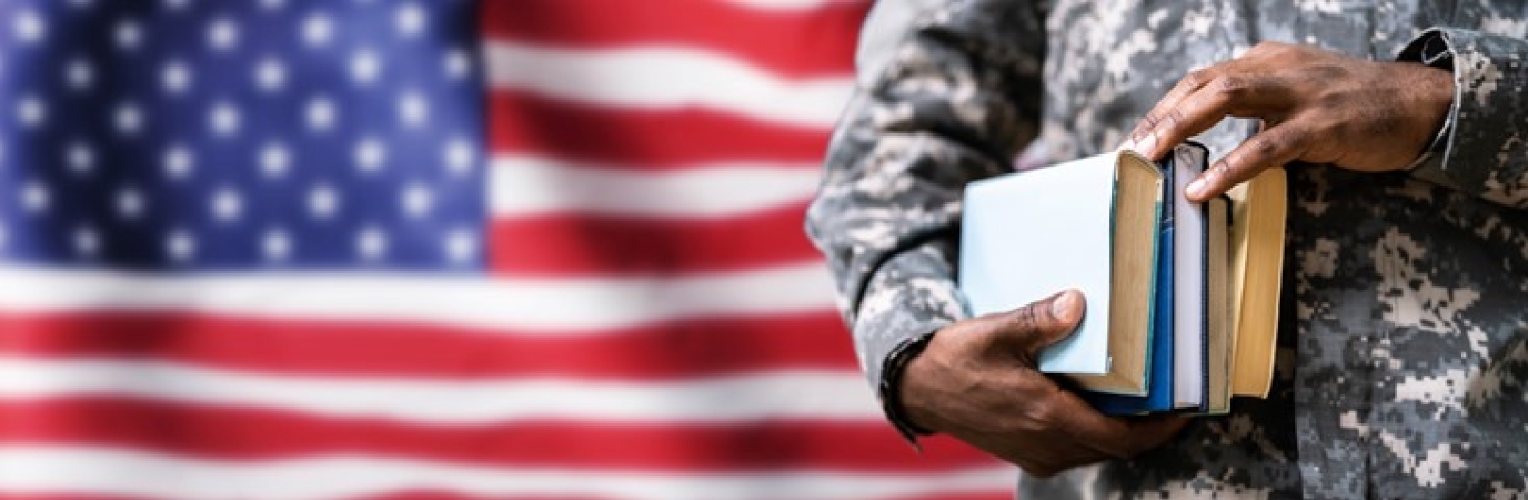 American flag in background with profile of student holding books