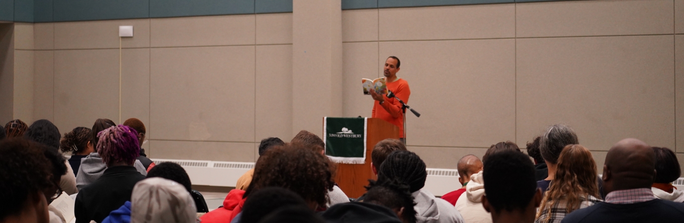 Acclaimed poet Ross Gay speaking to students during the Common Reader Poetry Reading event  