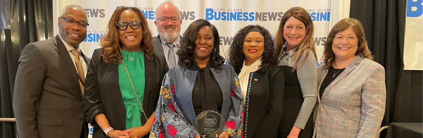 Shalei Simms with her award and six other people