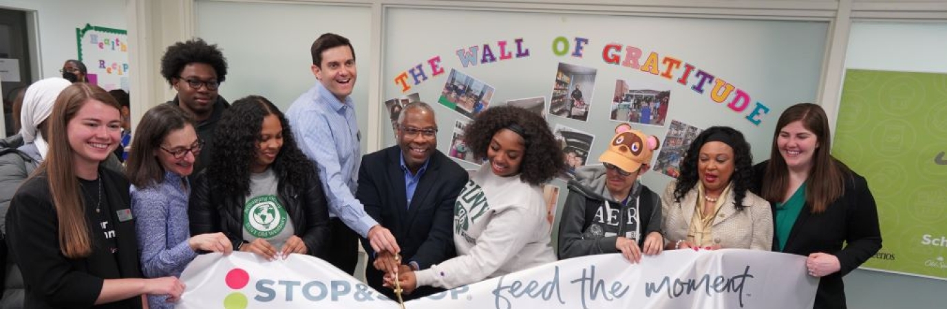 Ten people take part in a ceremonial ribbon cutting in the Panther Pantry