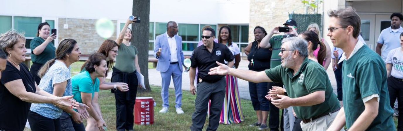 Staff members lined up for egg toss
