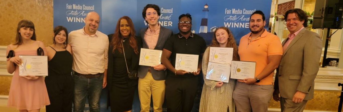 Nine students and faculty holding award certificates