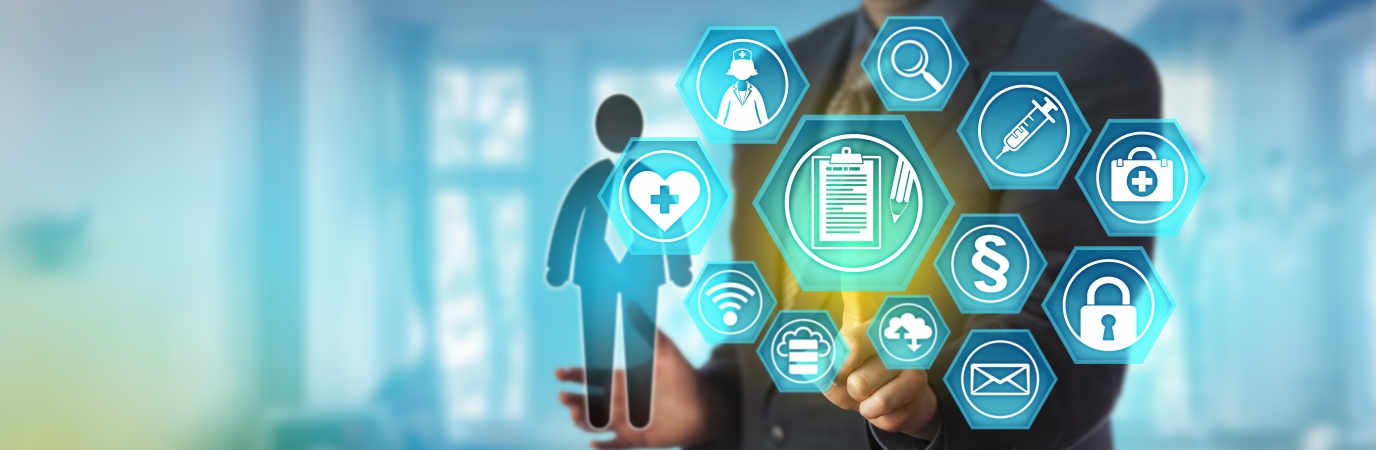 Healthcare icons on a translucent screen with a business executive pointing to them