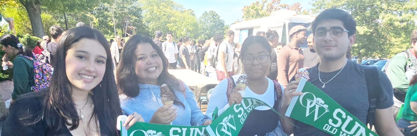Four freshman students holding OW banners
