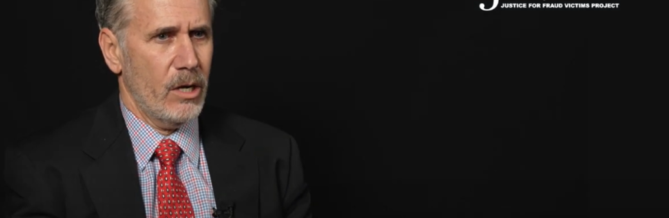 White man in suit and tie with text reading "JFVP: Justice for Fraud Victims Project" and "Dr. David Glodstein, associate professor"